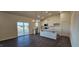 An open concept kitchen with stainless steel appliances, white cabinets, granite countertops, and a kitchen island at 141 Robert Howe Dr, Fuquay Varina, NC 27526