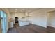 An open concept living room features recessed lighting, lots of natural light, and an open flow into the kitchen at 141 Robert Howe Dr, Fuquay Varina, NC 27526