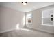 Well-lit bedroom with carpet and two large windows at 1527 Peabody Ct, Mebane, NC 27302