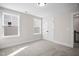 Well-lit bedroom with neutral decor, carpet, and double doors to closet at 1527 Peabody Ct, Mebane, NC 27302