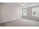 Bright bedroom with neutral walls, carpet, and two large windows at 1527 Peabody Ct, Mebane, NC 27302