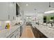 Modern kitchen showcasing white cabinets, stainless steel appliances, granite countertops, and seamless flow to dining area at 188 E Antebellum Dr # 37, Pittsboro, NC 27312