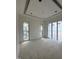 Large bedroom with tray ceilings and expansive windows providing ample natural light at 504 Colvard Woods Way Way, Durham, NC 27713
