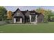 Stunning new construction home featuring a modern design with black brick and stone accents, plus professional landscaping at 504 Colvard Woods Way Way, Durham, NC 27713