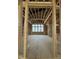 Unfinished room showcasing a large window, wooden beams, and the floor framing, ready for customization at 504 Colvard Woods Way Way, Durham, NC 27713