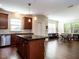 Modern kitchen with dark wood cabinets, granite island and breakfast bar at 713 Lake Artesia Ln, Fuquay Varina, NC 27526