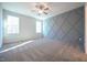 Spacious bedroom with gray geometric accent wall and carpet at 21 Abingdon Farms Dr, Selma, NC 27576