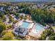 Aerial view of community pool and recreational facilities with lush landscaping and mature trees surrounding the area at 3009 Gentle Breezes Ln, Raleigh, NC 27614
