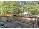 Outdoor deck features potted plants and a small metal table surrounded by lush trees at 3009 Gentle Breezes Ln, Raleigh, NC 27614