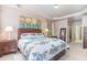 Bright bedroom featuring a tray ceiling, neutral walls, two windows, and a leather bed frame at 3009 Gentle Breezes Ln, Raleigh, NC 27614