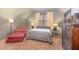 Charming bedroom with a gray color scheme, a window, and a red armchair at 3009 Gentle Breezes Ln, Raleigh, NC 27614