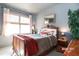 Cozy bedroom featuring a wood frame bed, accent pillows, and natural light from a window at 3009 Gentle Breezes Ln, Raleigh, NC 27614