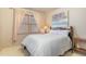Bright bedroom featuring neutral walls, a window, and a wood bed frame with white bedding at 3009 Gentle Breezes Ln, Raleigh, NC 27614
