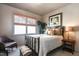 Comfortable bedroom with a window, neutral walls, and a wood bed frame with brown bedding at 3009 Gentle Breezes Ln, Raleigh, NC 27614