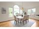 Dining room area featuring large windows with lots of natural light and views of the backyard at 3009 Gentle Breezes Ln, Raleigh, NC 27614