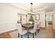An open dining room features hardwood floors, bright lighting and a wooden dining table at 3009 Gentle Breezes Ln, Raleigh, NC 27614
