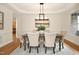 Traditional dining room with chandelier, neutral paint color, and hardwood flooring at 3009 Gentle Breezes Ln, Raleigh, NC 27614