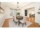 An open dining room features hardwood floors, bright lighting and a large wooden dining table at 3009 Gentle Breezes Ln, Raleigh, NC 27614