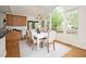 Bright dining room featuring a white table set with seating for six and a large window with outside views at 3009 Gentle Breezes Ln, Raleigh, NC 27614