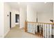 Upstairs hallway with hardwood floors features a staircase and access to other rooms at 3009 Gentle Breezes Ln, Raleigh, NC 27614