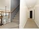 Hallway features carpeted stairs with dark wood handrail and neutral wall colors at 3009 Gentle Breezes Ln, Raleigh, NC 27614