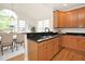 Kitchen and dining room combination with hardwood floors, wood cabinets and granite counters at 3009 Gentle Breezes Ln, Raleigh, NC 27614