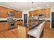 Bright kitchen boasts stainless steel appliances, kitchen island and wood cabinets at 3009 Gentle Breezes Ln, Raleigh, NC 27614