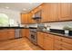 Traditional kitchen featuring stainless appliances, wood cabinets, and granite countertops at 3009 Gentle Breezes Ln, Raleigh, NC 27614
