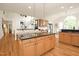 Spacious kitchen with island and bar seating plus light wood cabinets and hardwood floors at 3009 Gentle Breezes Ln, Raleigh, NC 27614