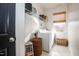 Bright laundry room featuring white walls, a window, white appliances, and wire shelves at 3009 Gentle Breezes Ln, Raleigh, NC 27614