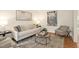 Bright living room features neutral furniture, decorative rug and statement art at 3009 Gentle Breezes Ln, Raleigh, NC 27614