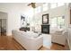 Open living room with a fireplace, hardwood floors, large windows, and neutral furniture at 3009 Gentle Breezes Ln, Raleigh, NC 27614
