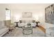 Cozy living room with a sofa, armchairs, stylish decor, and a decorative rug at 3009 Gentle Breezes Ln, Raleigh, NC 27614