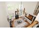 Open living area with high ceilings, large windows, a fireplace, and modern furnishings at 3009 Gentle Breezes Ln, Raleigh, NC 27614