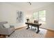 Bright office features a large window, hardwood floors, a decorative rug and statement artwork at 3009 Gentle Breezes Ln, Raleigh, NC 27614