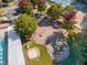 Aerial view of the playground with swings, slides, a sandbox, and picnic benches for residents at 3009 Gentle Breezes Ln, Raleigh, NC 27614