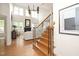 Elegant staircase with hardwood steps and black iron railings leading to the living area at 3009 Gentle Breezes Ln, Raleigh, NC 27614
