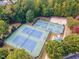 Aerial shot of tennis courts surrounded by mature trees offering a vibrant recreational space at 3009 Gentle Breezes Ln, Raleigh, NC 27614