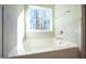 Relaxing bathtub with tile surround and large window at 49 Abingdon Farms Dr, Selma, NC 27576