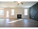 Spacious living room with hardwood floors, fireplace, and a ceiling fan at 49 Abingdon Farms Dr, Selma, NC 27576