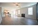 Open living room with hardwood floors, kitchen, and fireplace at 49 Abingdon Farms Dr, Selma, NC 27576