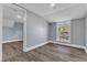 Upstairs bedroom with wood-look floors and window at 505 S Magnolia Ave, Dunn, NC 28334