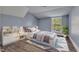 Cozy bedroom with a large window, stylish decor, and a comfortable bed on top of an accent rug at 505 S Magnolia Ave, Dunn, NC 28334