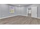 Bright bedroom with wood-look floors and an adjacent bathroom at 505 S Magnolia Ave, Dunn, NC 28334