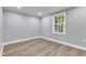 Empty bedroom with wood-look floors and a window at 505 S Magnolia Ave, Dunn, NC 28334