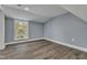 Bright bedroom with wood-look floors and a large window at 505 S Magnolia Ave, Dunn, NC 28334