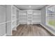 Spacious walk-in closet with built-in shelves and hanging rods at 505 S Magnolia Ave, Dunn, NC 28334