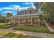 Charming home with a metal roof, brick accents, and an inviting front porch on a tree-lined street at 505 S Magnolia Ave, Dunn, NC 28334