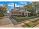 Stunning two-story home boasts a metal roof, brick accents, inviting front porch, and detached garage at 505 S Magnolia Ave, Dunn, NC 28334