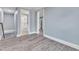 Upstairs hallway with wood-look floors and access to bathroom and bedroom at 505 S Magnolia Ave, Dunn, NC 28334